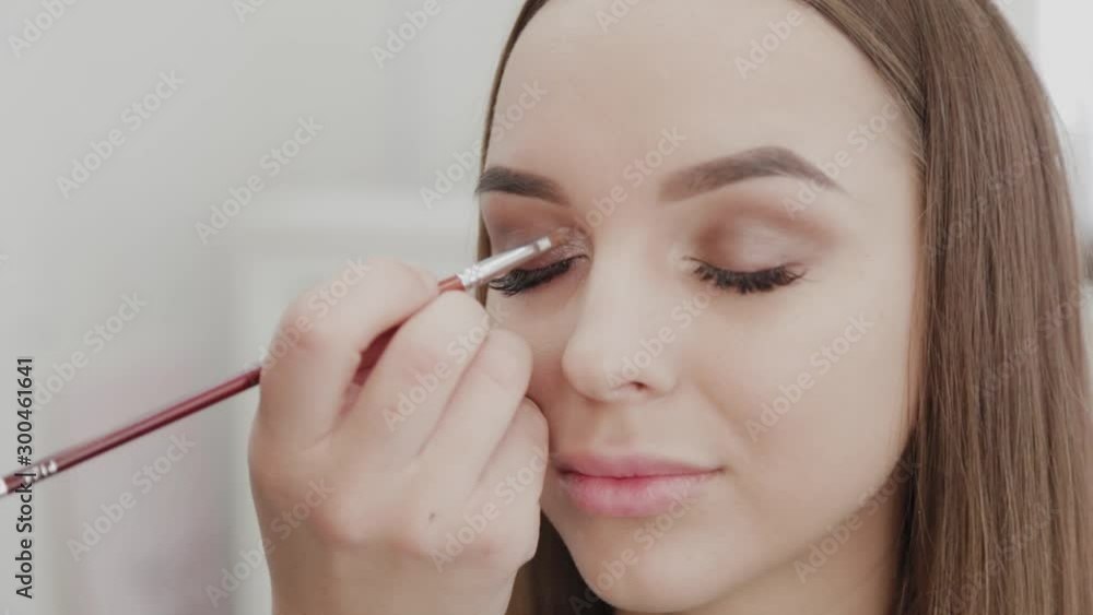 Professional makeup artist woman stirs makeup cream on a palette. Professional makeup artist woman stirs makeup cream on a palette.