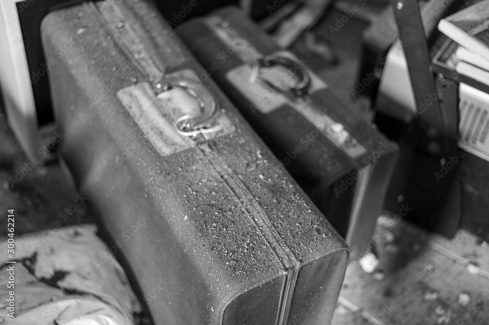 A set of abandoned luggage in an attic A set of abandoned luggage in an attic
