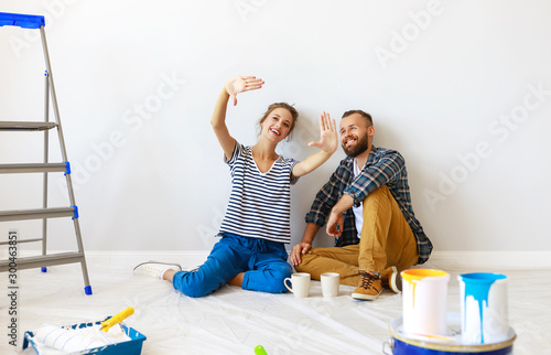 young happy family married couple dreams of renovating  house and planning  design project. photo