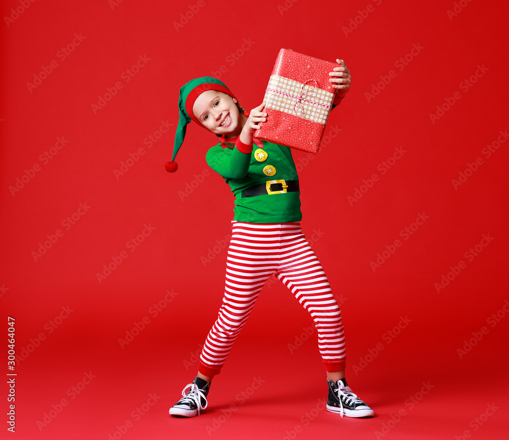Cheerful Funny Baby In Christmas Elf Costume With Gifts On Red Background Stock Photo Adobe Stock