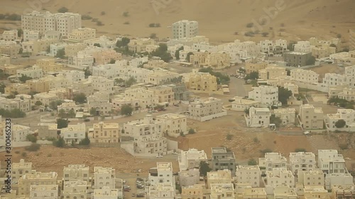 Top view of the Omani city. Deserted eastern area. Roofs of cars, road cars. Panorama of the area.