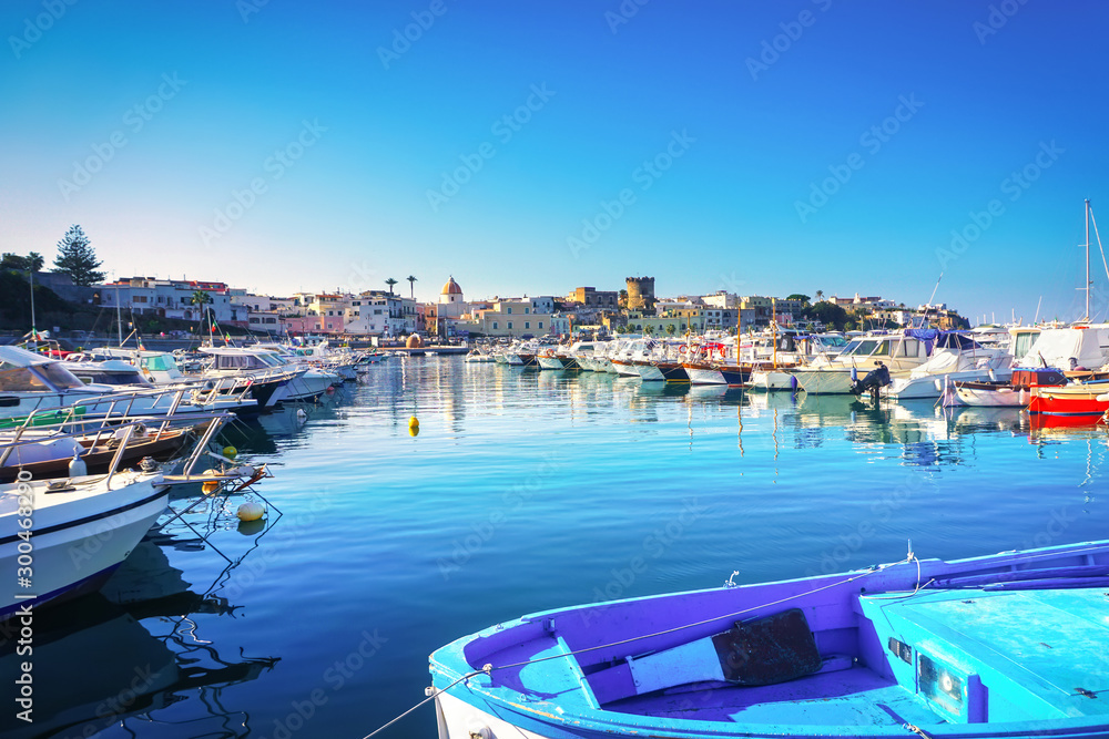 Ischia island and boats in Forio marina. Campania, Italy.