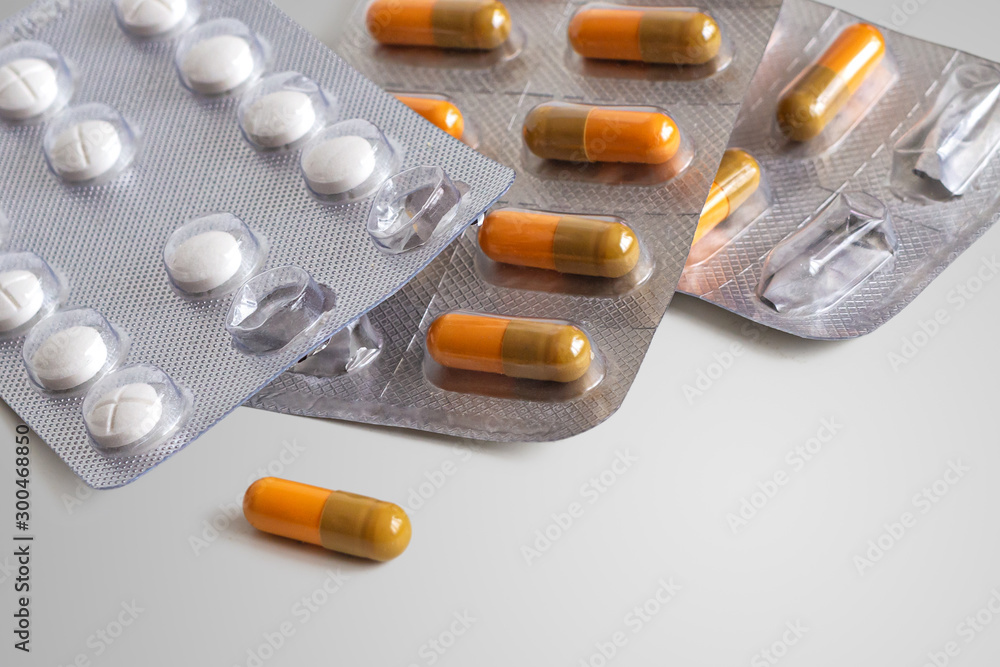 Packaging of medical capsules and tablets on a white background Packaging of medical capsules and tablets on a white background