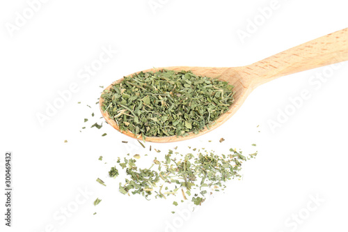 Wooden spoon with dried parsley on white background