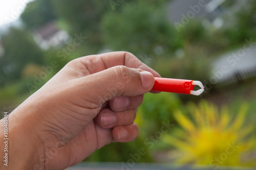 Red  Extractor for removing ticks,TICK TWISTER in a hand