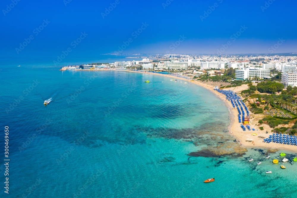 Panorama of Cyprus from a height. Turquoise sea and blue sky. Expanse. Rest on the Mediterranean sea. Kalamies Beach. Seaside resort. Sandy beaches along the coast. Holidays in Cyprus.