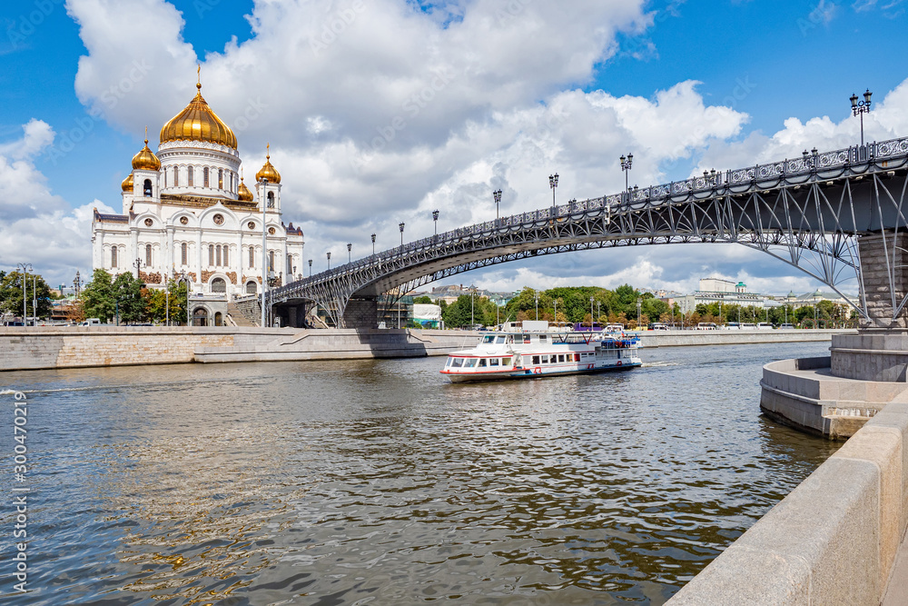 Moscow on a summer day. Cathedral Of Christ The Saviour. Ship on the river Moscow. Boat trips on the river Moscow. Patriarch bridge. The bridge leads to the temple. Summer trip to Russia.