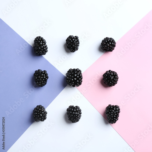 Fresh ripe blackberries on color background, flat lay