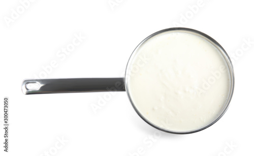 Delicious creamy sauce in pan on white background, top view