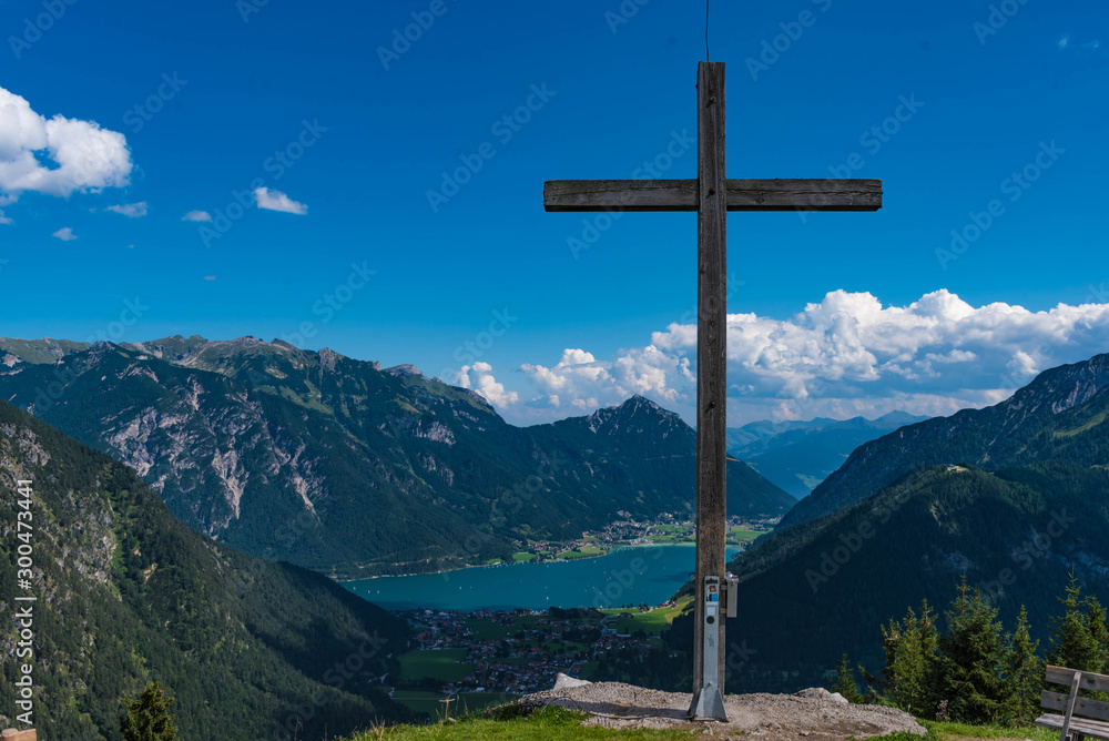 cross in the mountains with view to the lake achensee, tyrol cross in the mountains with view to the lake achensee, tyrol