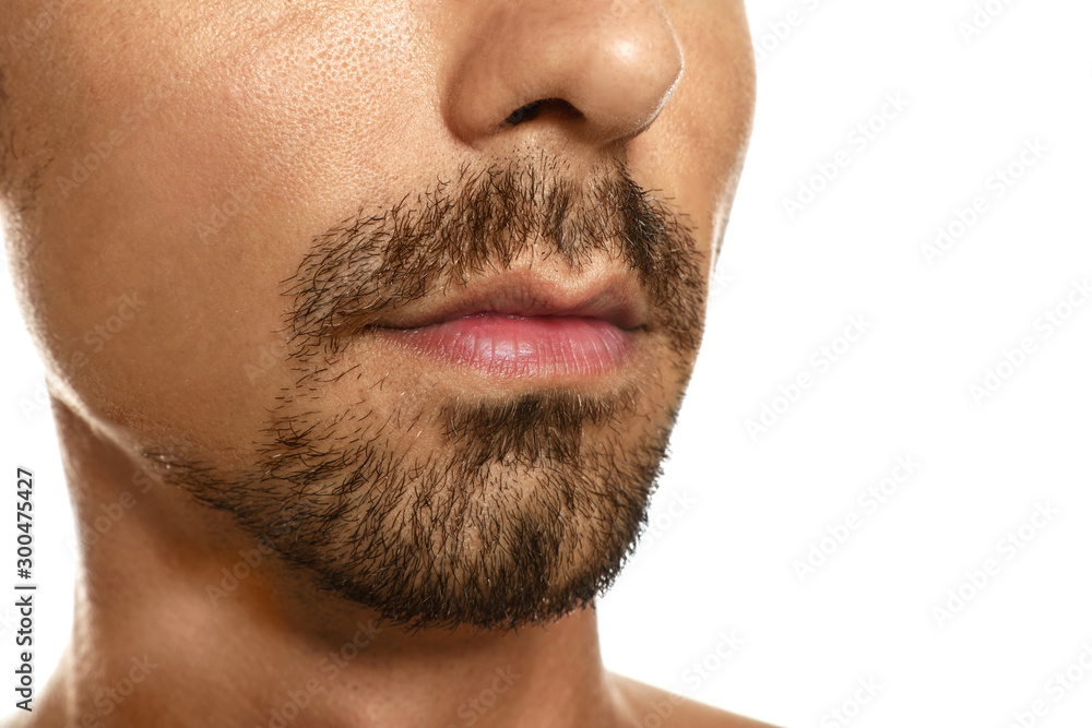 Fototapeta premium Young man with cold sore on lips against white background, closeup