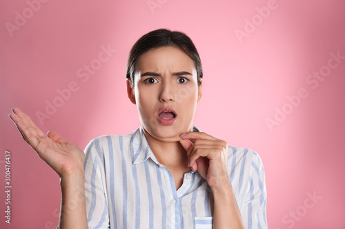 Photos Emotional young woman with double chin on pink background