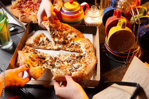 Hands of people with slices...