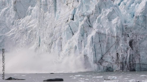 Glacier calving in Alaska. Glacier Bay Alaska cruise vacation travel. Global warming and climate change concept with melting ice falling in water. landscape of Margerie Glacier.
