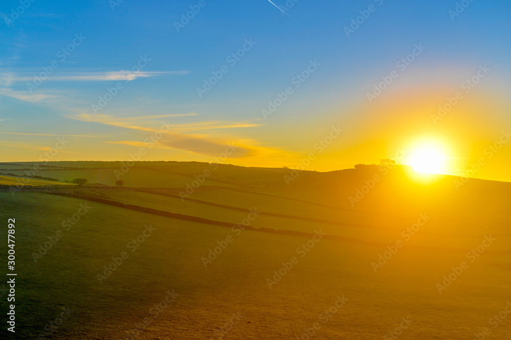 sunrise over green fields 