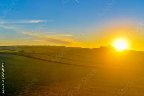 sunrise over green fields 
