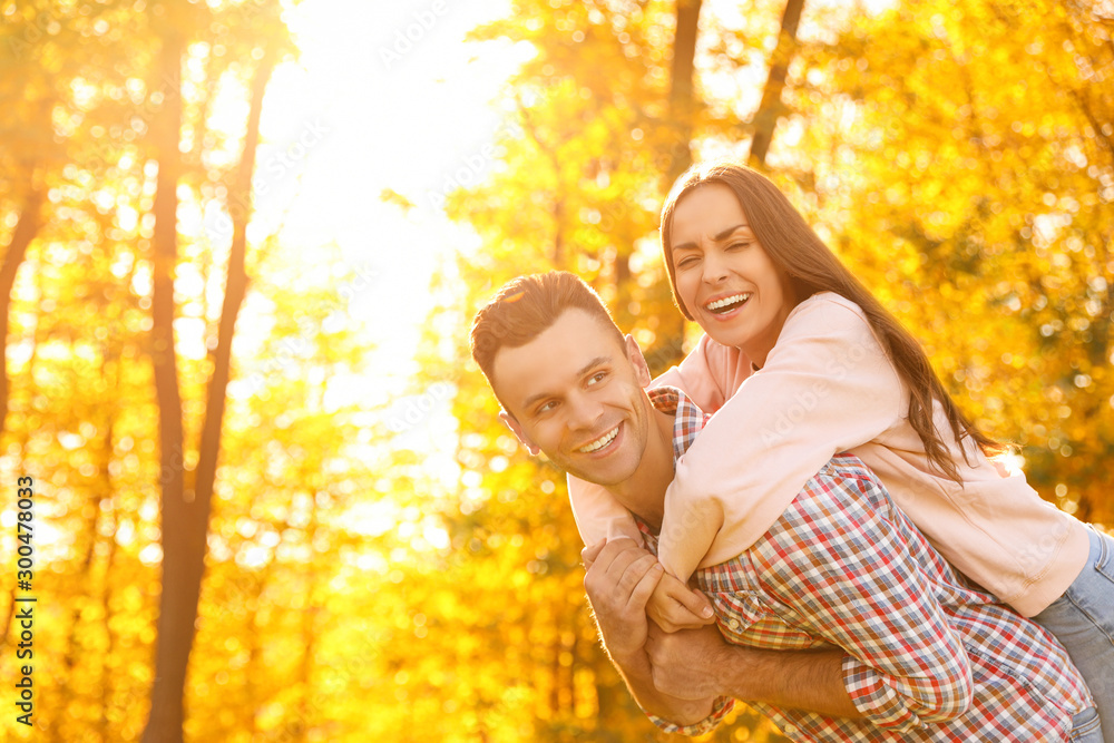Happy couple in sunny park. Autumn walk Happy couple in sunny park. Autumn walk