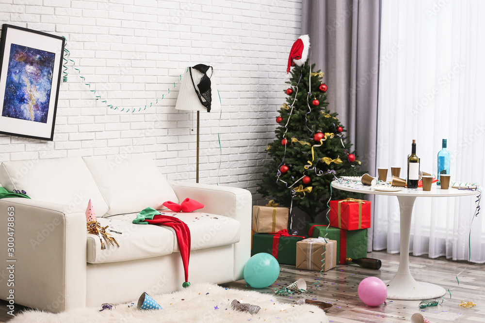 Messy living room interior with Christmas tree. Chaos after party - obrazy, fototapety, plakaty 