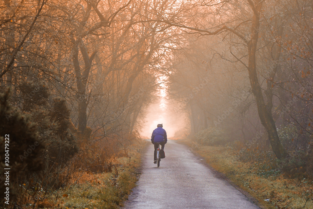 cyclist on misty country lane