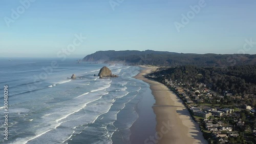 Haystack Rock at Cannon Beach in Oregon. Aerial 4K footage of ocean, beach and coast. photo