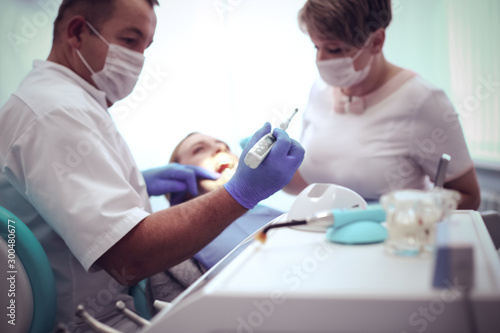 Detail of hand holding dental tools in dental clinic. Dentist Concept photo