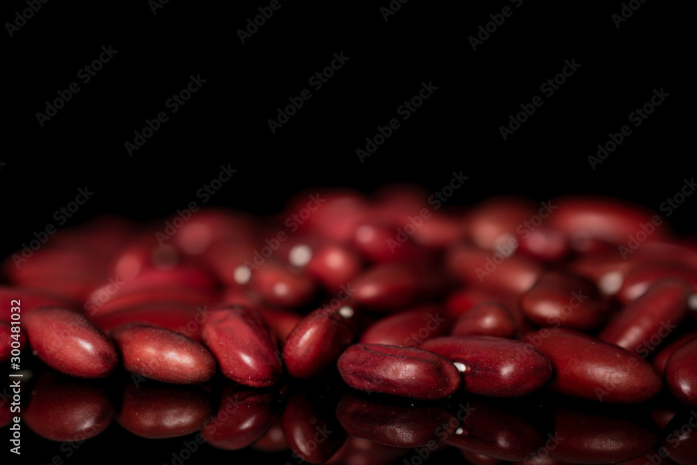 Lot of whole diet fresh red kidney beans isolated on black glass Lot of whole diet fresh red kidney beans isolated on black glass