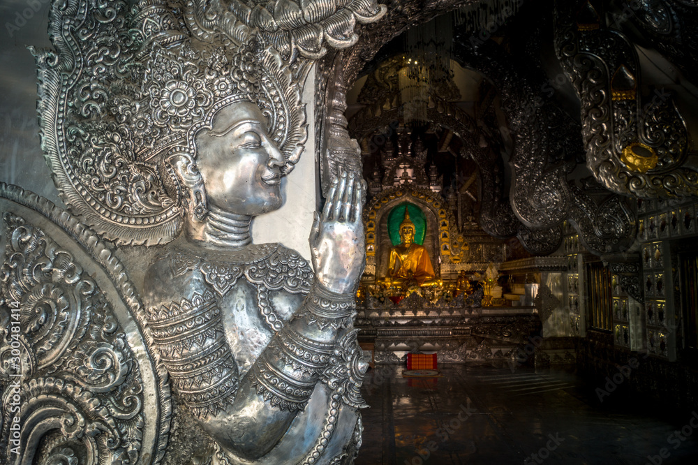silver buddha statue in thai temple
