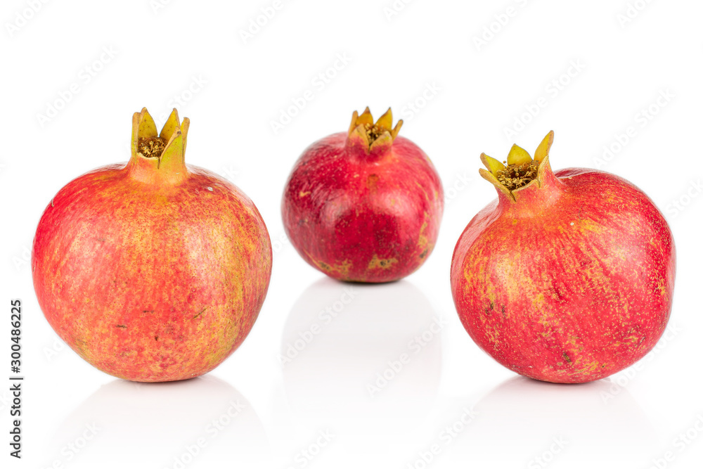Group of three whole fresh red pomegranate isolated on white background Group of three whole fresh red pomegranate isolated on white background