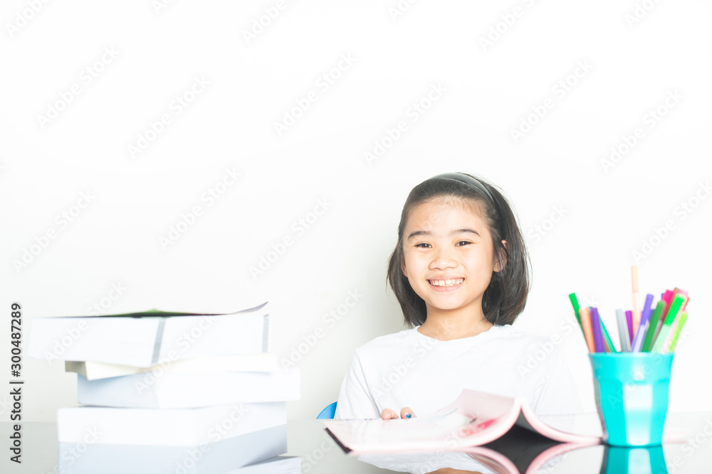 Asian girls are enjoying their homework as assigned by the teachers at the school. At his own home. Asian girls are enjoying their homework as assigned by the teachers at the school. At his own home.