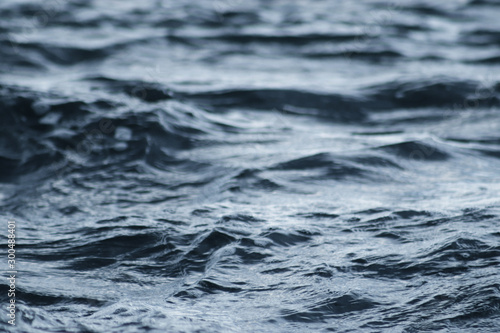 Beautiful blue sea water surface with low waves. Seascape background. Calm Dark Sea Waves. Close-up, shallow focus.