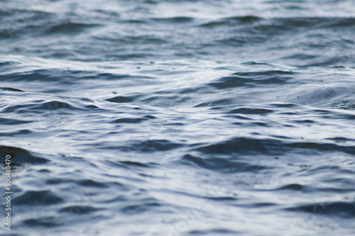 Beautiful blue sea water surface with low waves. Seascape background. Calm Dark Sea Waves. Close-up, shallow focus.