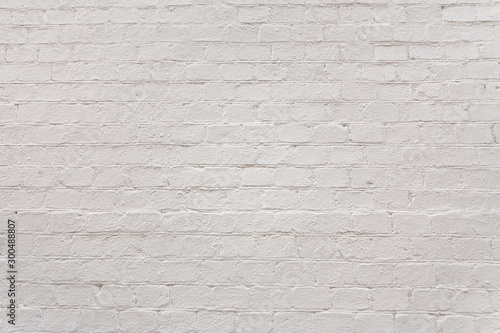 Bright textured painted white brick wall