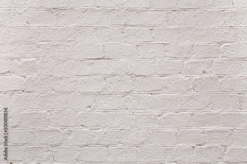 Bright textured painted white brick wall