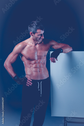 muscular man holding blank.