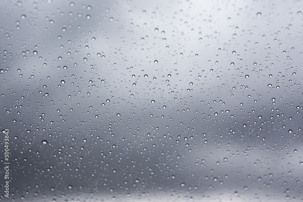 Rain drops on car window glass and Rain clouds background Rain drops on car window glass and Rain clouds background