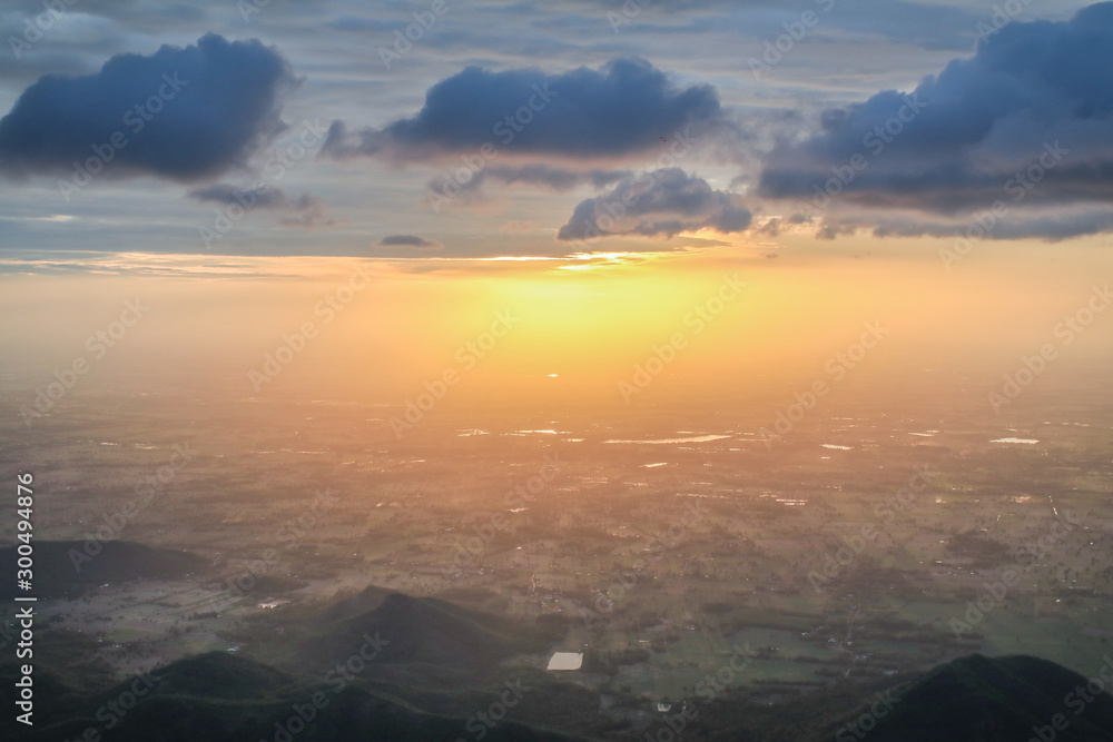 Fototapeta premium Aerial view of mountains with cloud cover mountain at sunrise and blue sky on Khao Luang mountain in Ramkhamhaeng National Park,Sukhothai province Thailand Rocky cliff with beautiful View