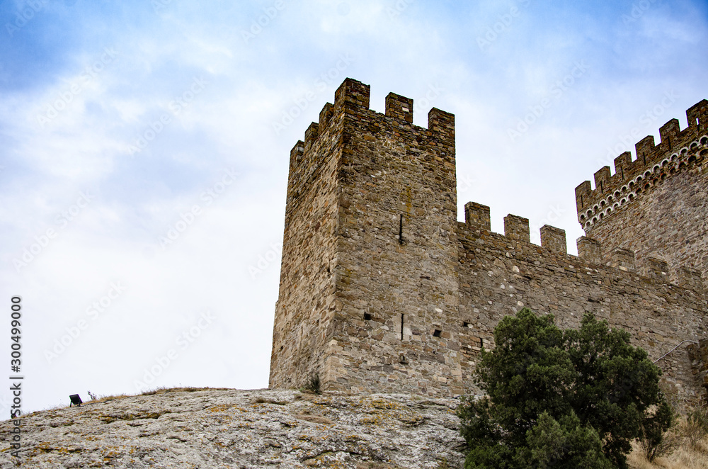 Tower of an old medieval fortress in the mountains. Tower of an old medieval fortress in the mountains.