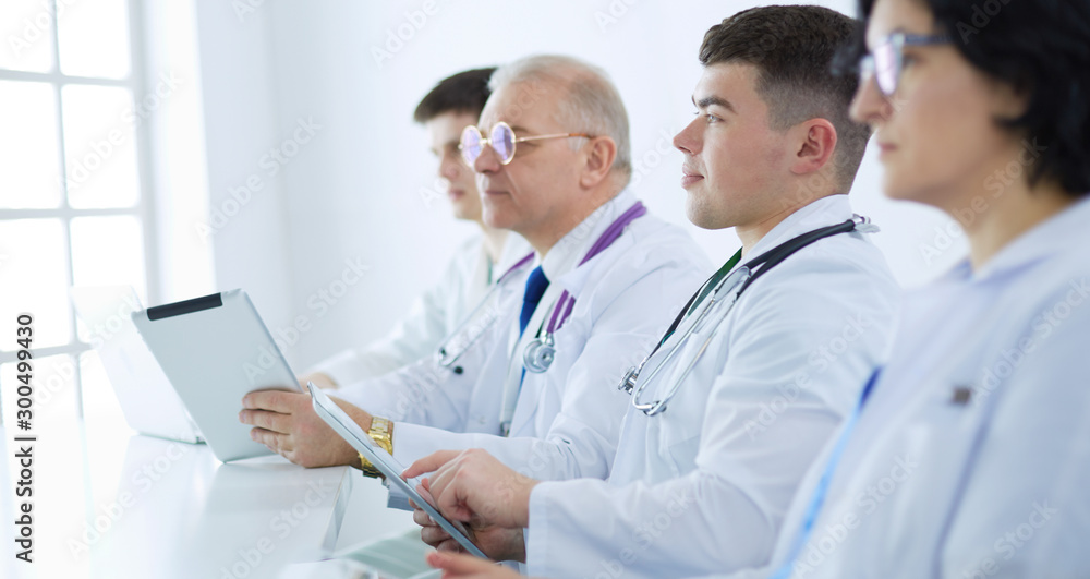 Medical team sitting and discussing at table Medical team sitting and discussing at table