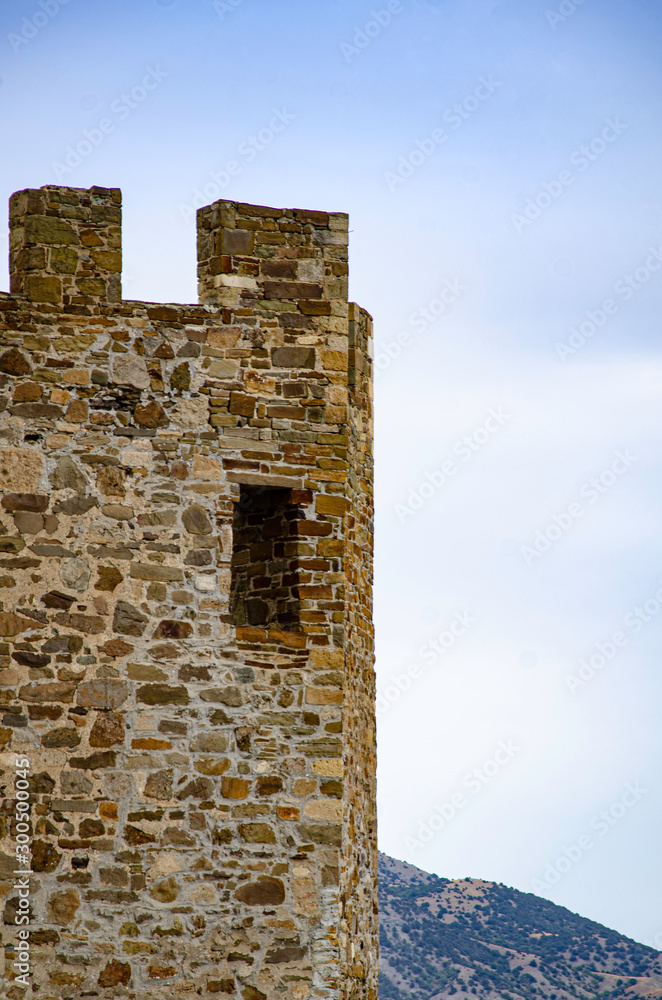 Tower of an old medieval fortress in the mountains.