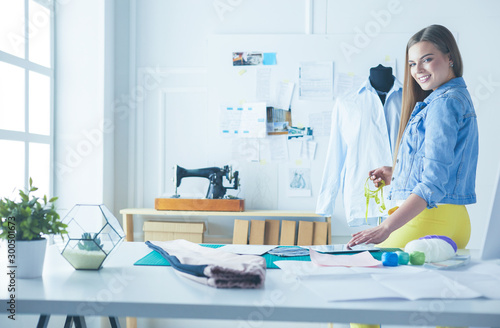 Fashion designer working on her designs in the studio