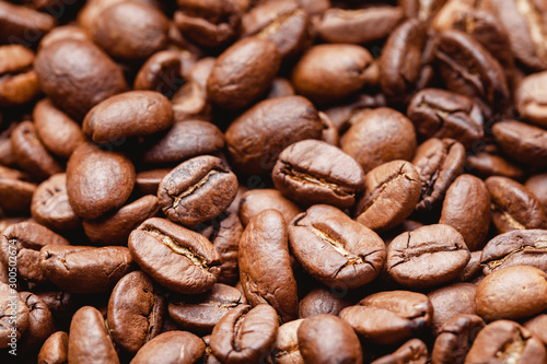 Coffee beans texture. Morning energy roasted brown beans background.