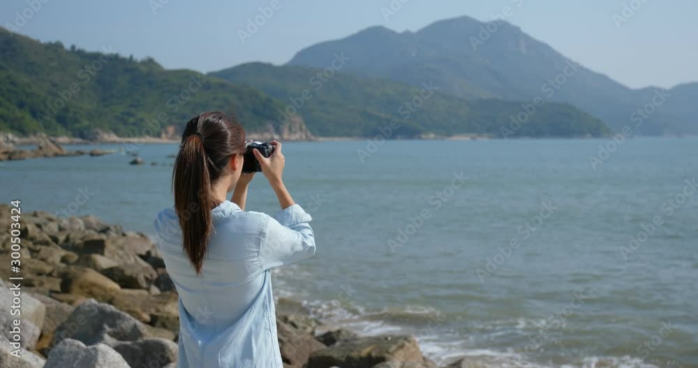 Woman take photo at the sea