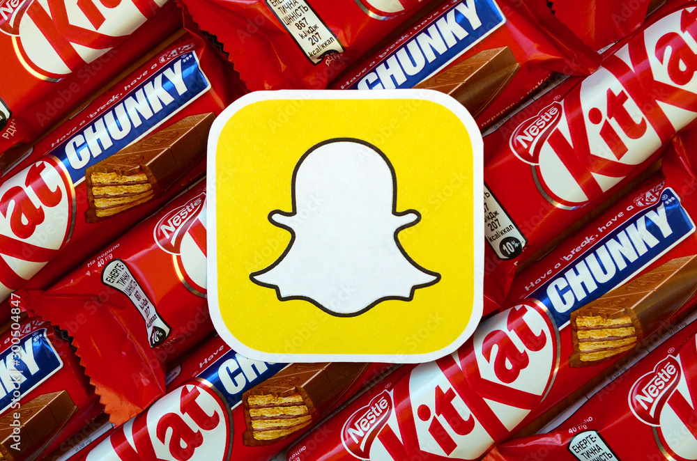 Snapchat paper logo on many Kit Kat chocolate covered wafer bars in red