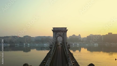 Morning sunrise in capital of Hungary, Budapest. View of the bridge over the river and the cathedral against the sky where the sun rises. Panorama of the city from the drone. Top view. Aerial footage.