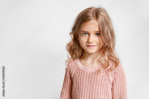 Cute little girl on light b...