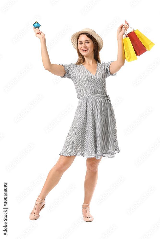 Beautiful young woman with shopping bags and credit card on white background Beautiful young woman with shopping bags and credit card on white background