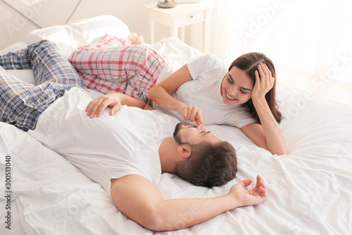 Happy young couple lying on...