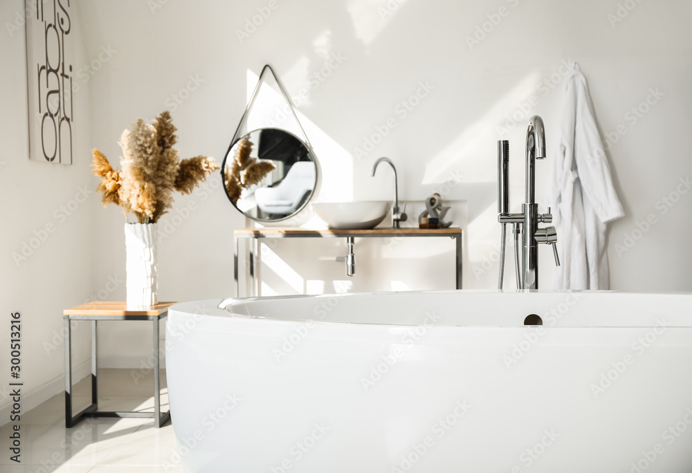 Modern ceramic bathtub in light interior - obrazy, fototapety, plakaty 