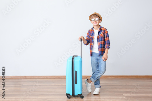 Cute little boy with suitca...