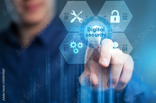 Business, Technology, Internet and network concept. Young businessman working on a virtual screen of the future and sees the inscription:Digital security .